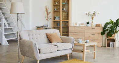 Living room with a sofa, rug, and hardwood floors adding value to a house