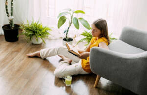 Devojčica čita knjigu na podu / foto: freepik.com